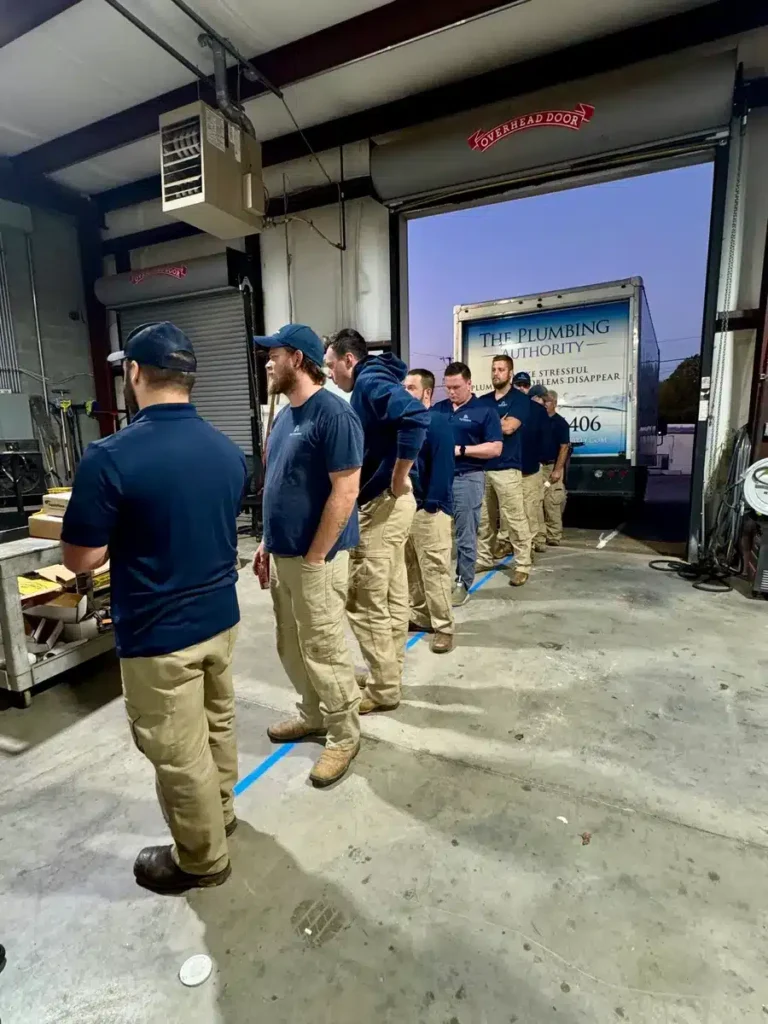 Crew lining up in the shop for a hands-on Winning Wednesday challenge