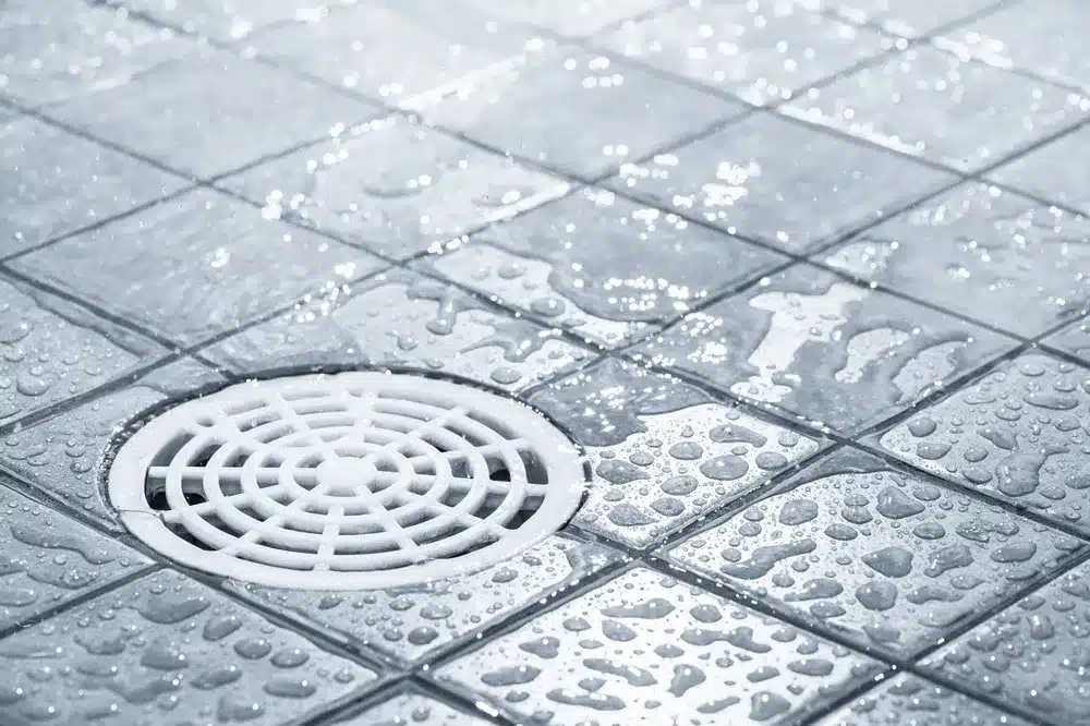 water flowing down drain in shower
