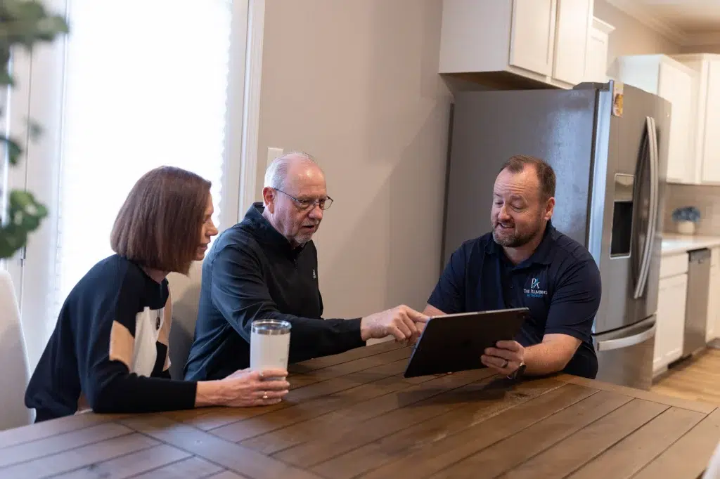 Technician helping customer at kitchen table in Knoxville, TN.