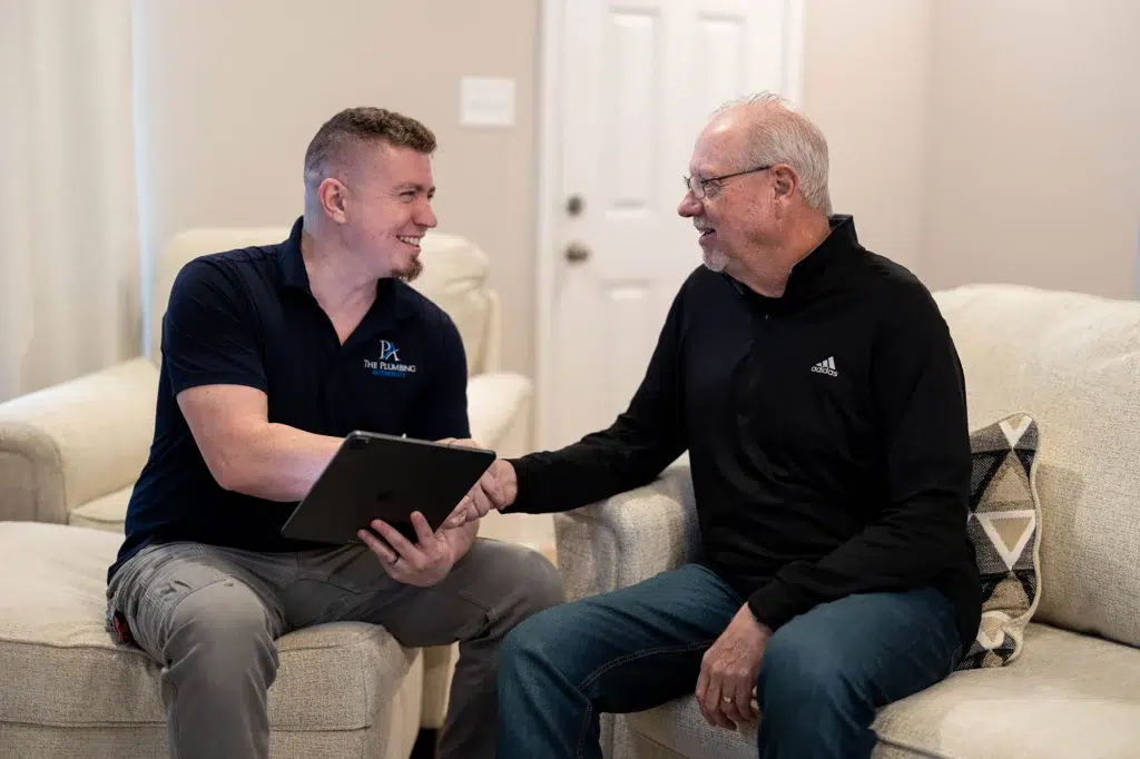 The Plumbing Authority technician shaking hands with customer in Knoxville, TN.