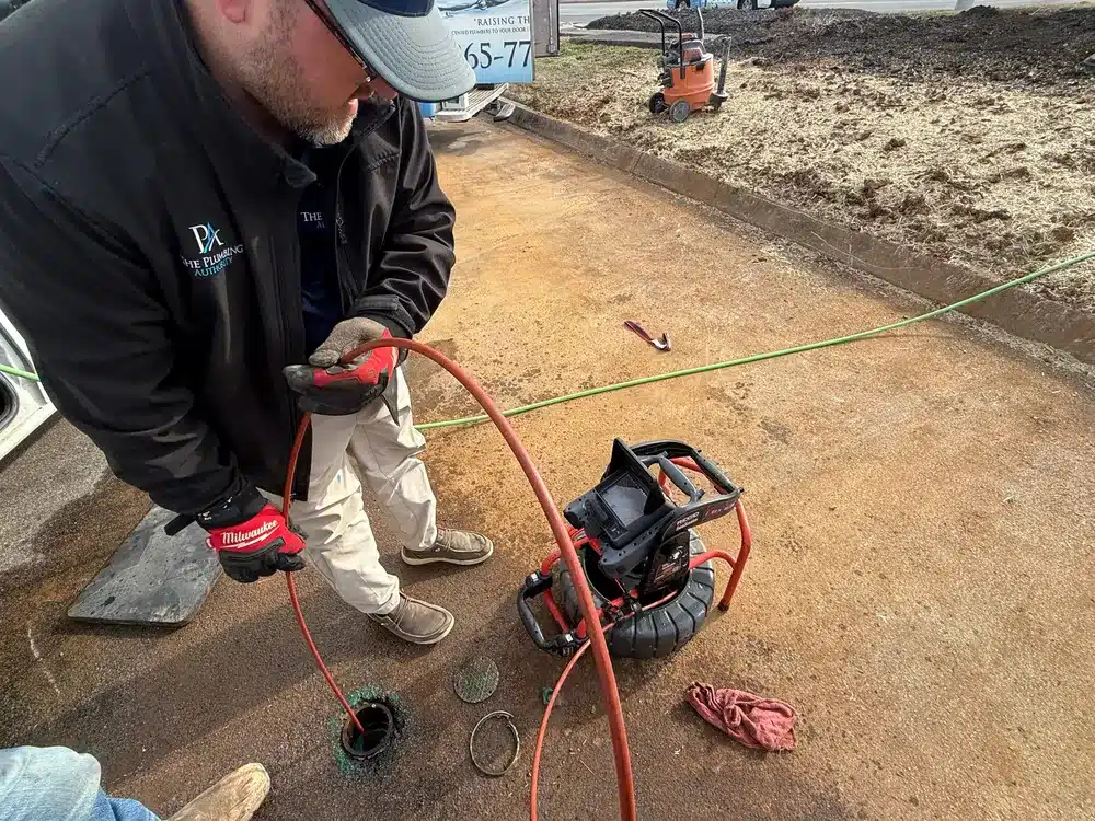 tech using camera for sewer line inspection