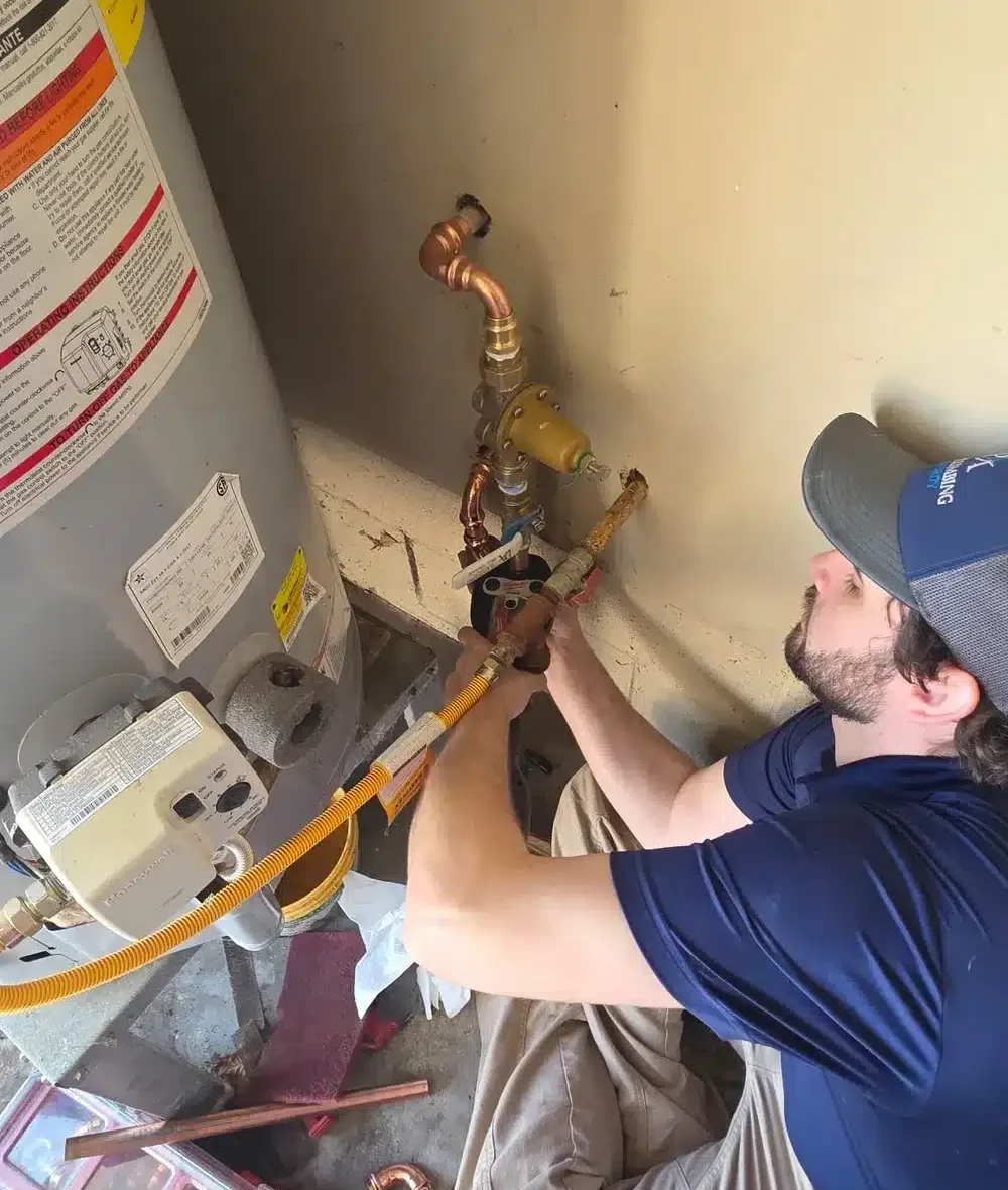 tech working on water heater