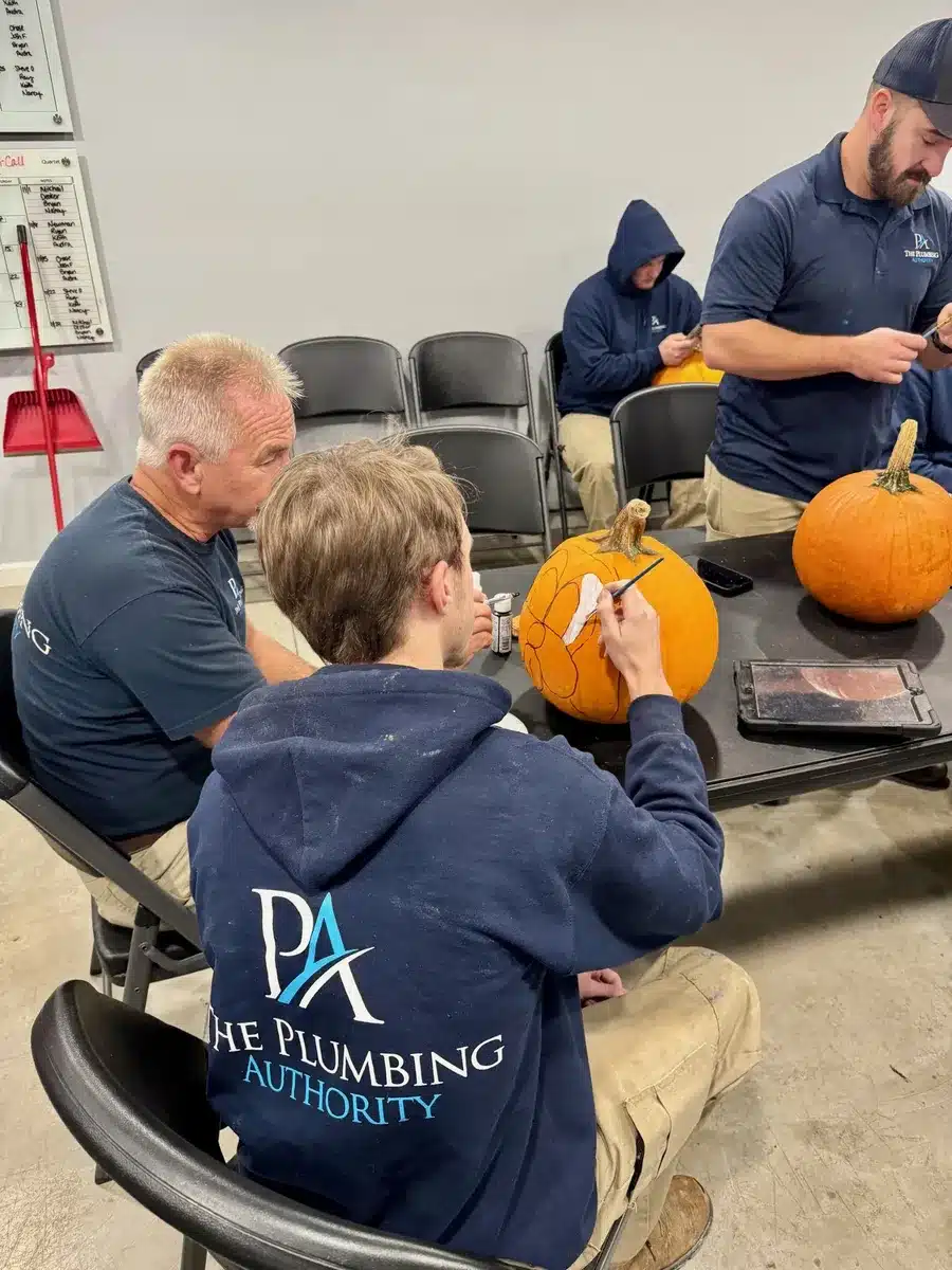 Employees carving pumpkins together during a Winning Wednesday event