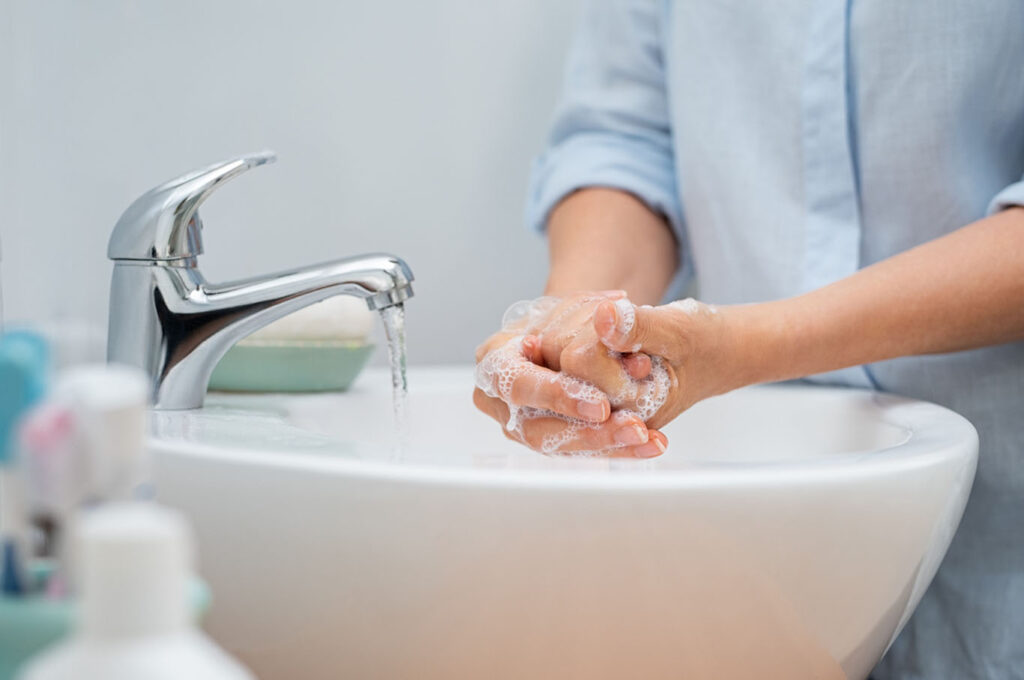 washing hands in bathroom sink
